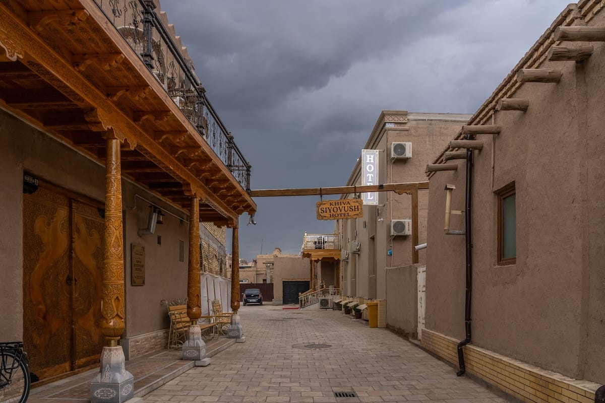 a quiet street in an old city with a stormy sky