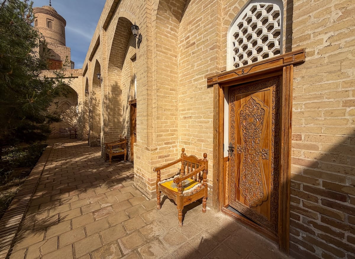 a door with a chair in front of it at a hotel in khiva