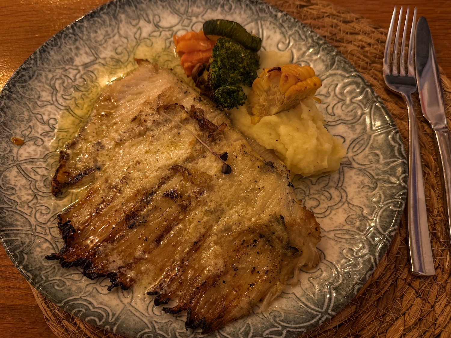 a ray wing in a garlic butter sauce on a plate