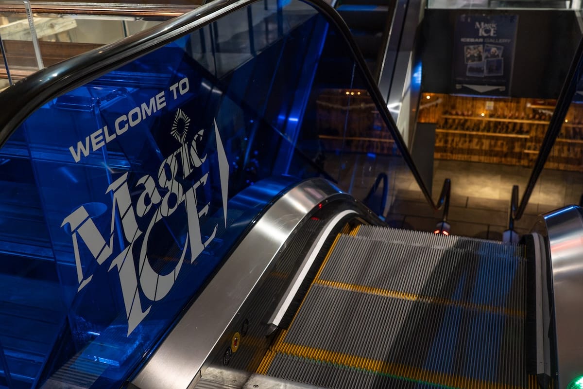 an escalator with words 'magic ice' written on it