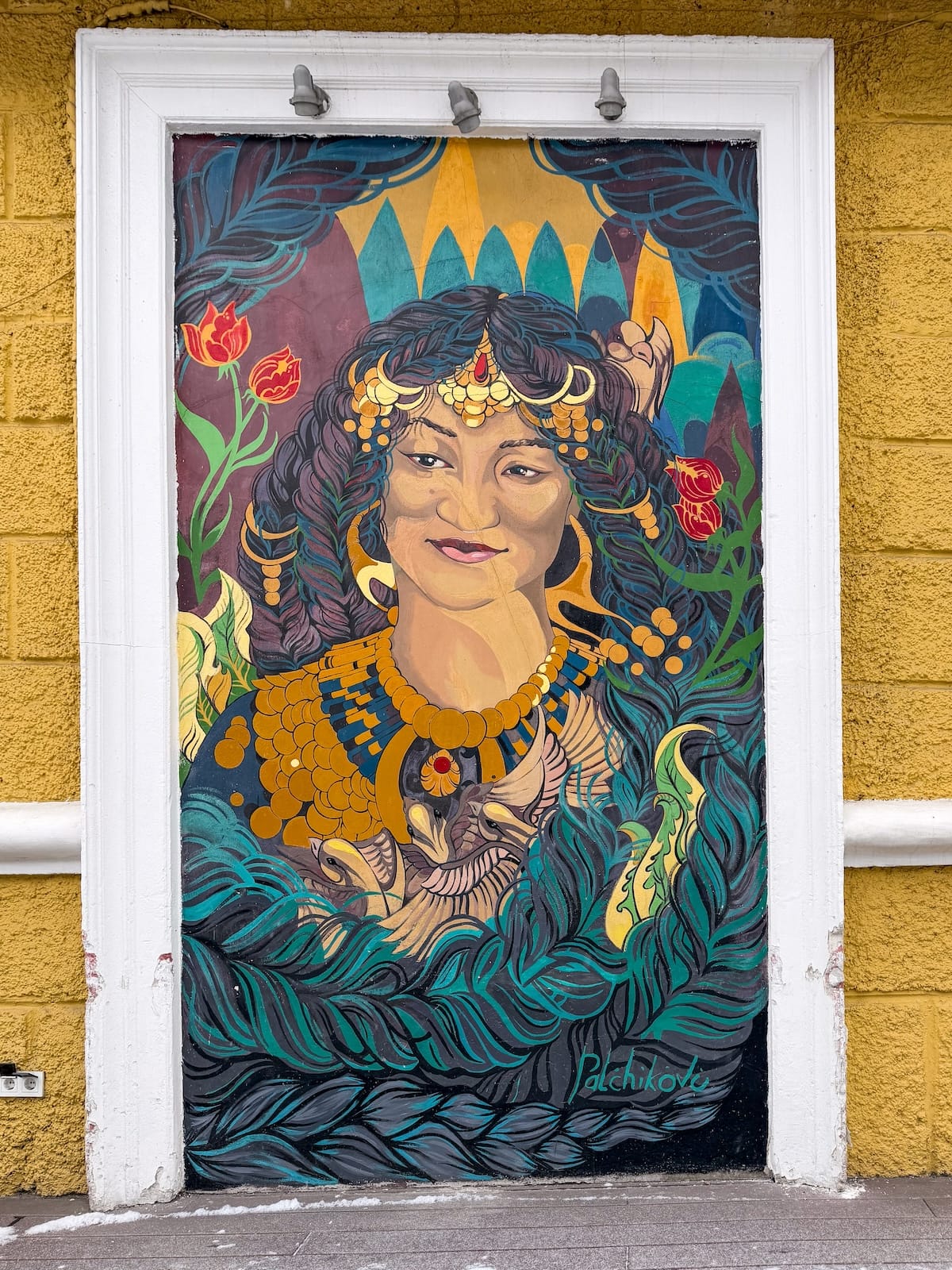 a mural on a yellow building in almaty / street art in almaty