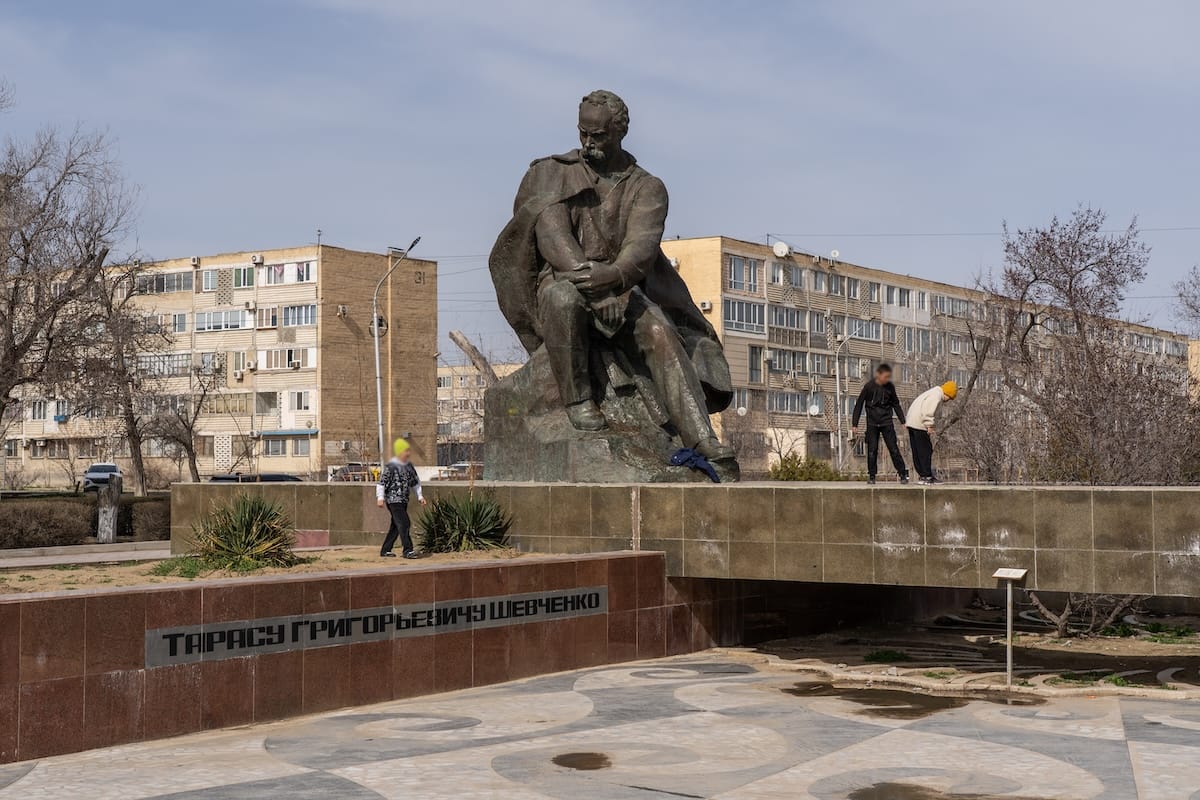 a monument of taras shevchenko and children playing around it