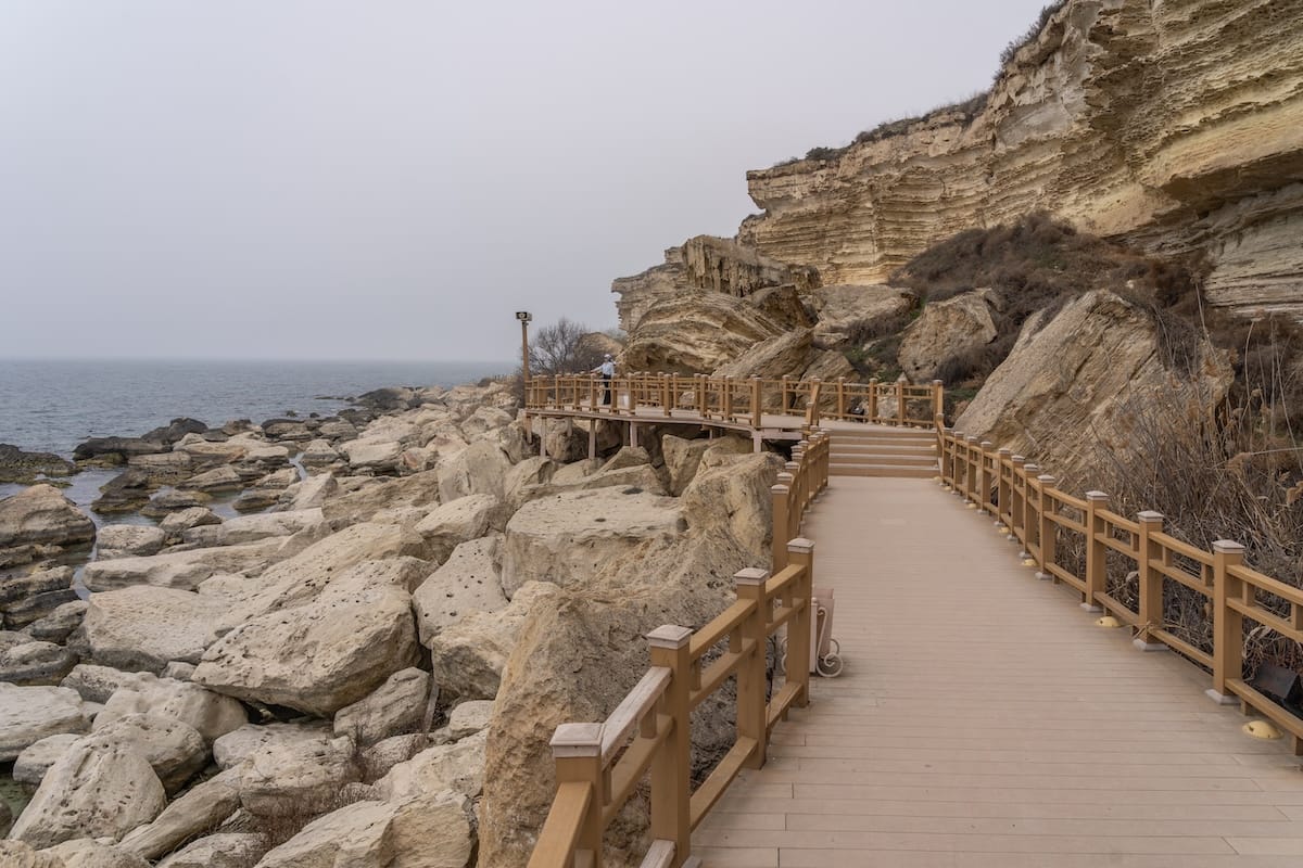 a foggy caspian sea with a promenade