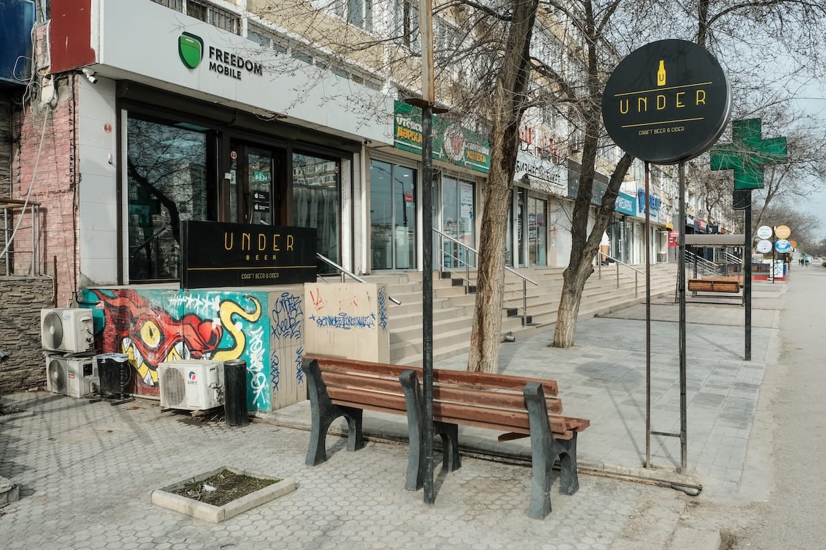 an underground bar with a bench in front of it