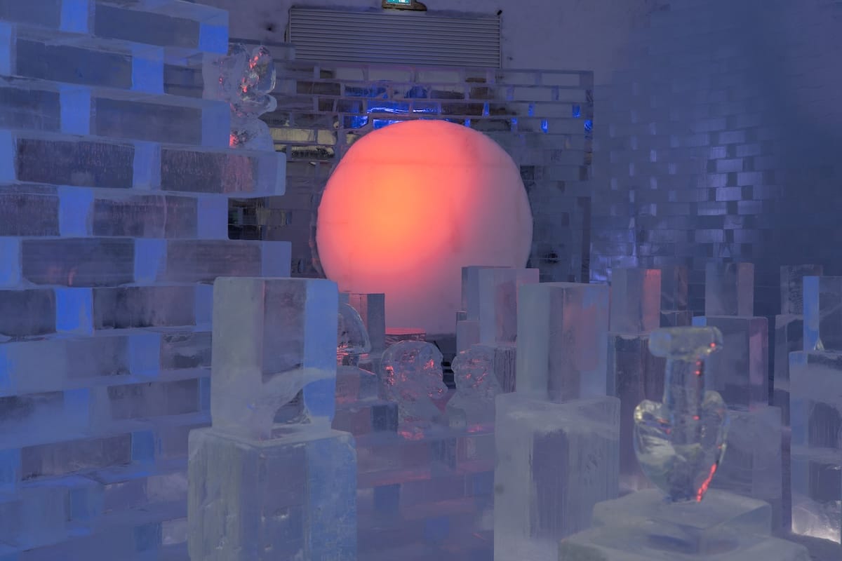 a purple and blue room with a pink sphere all made out of ice