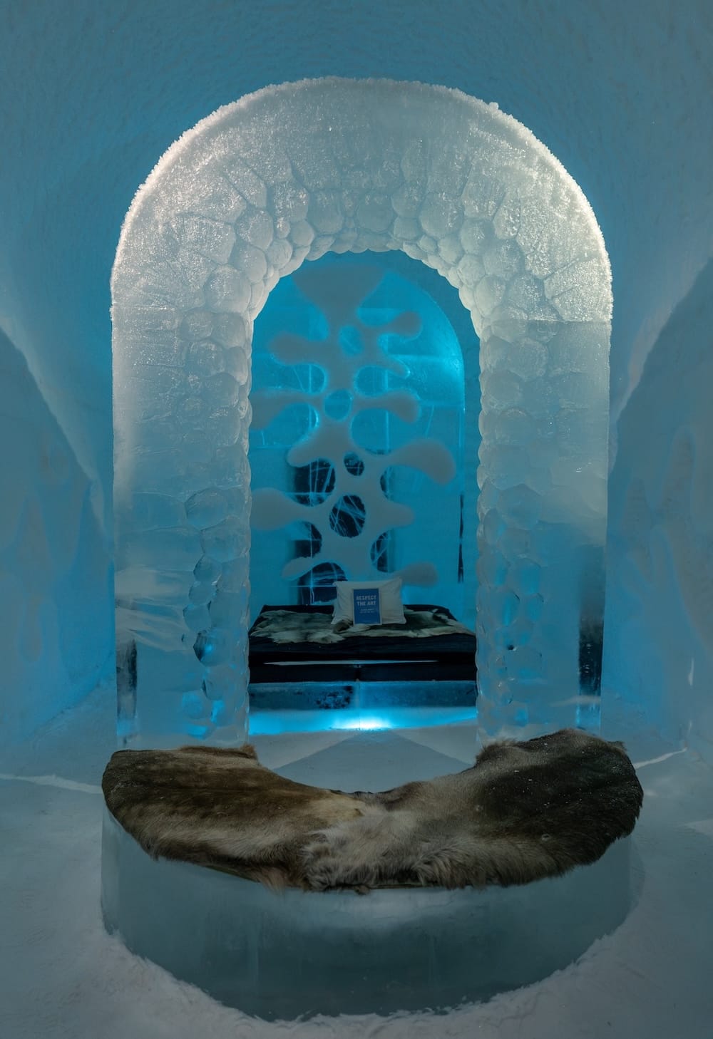 One of the ice rooms at ICEHOTEL

A room made of ice with a bed and bench in the middle of it