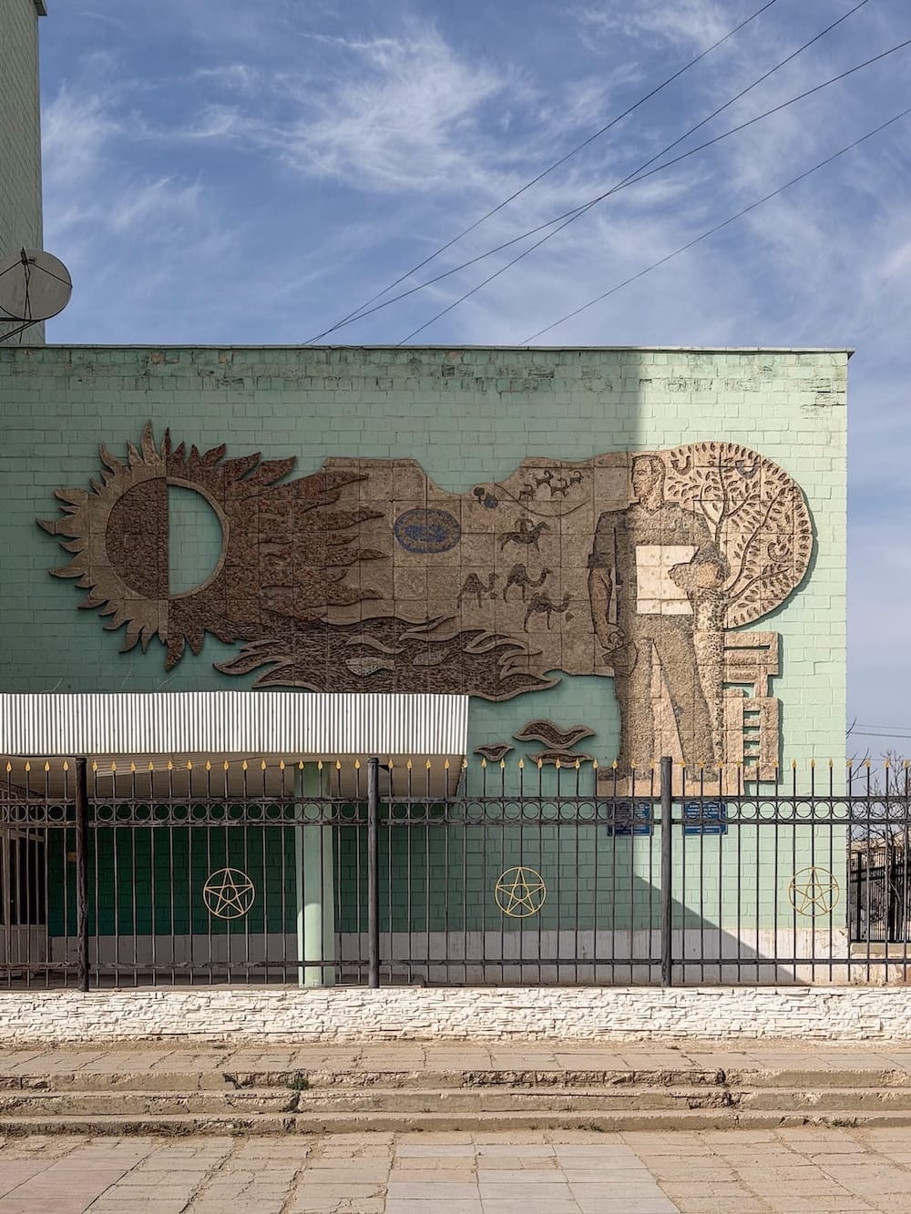 a mosaic-relief on a green building in aktau