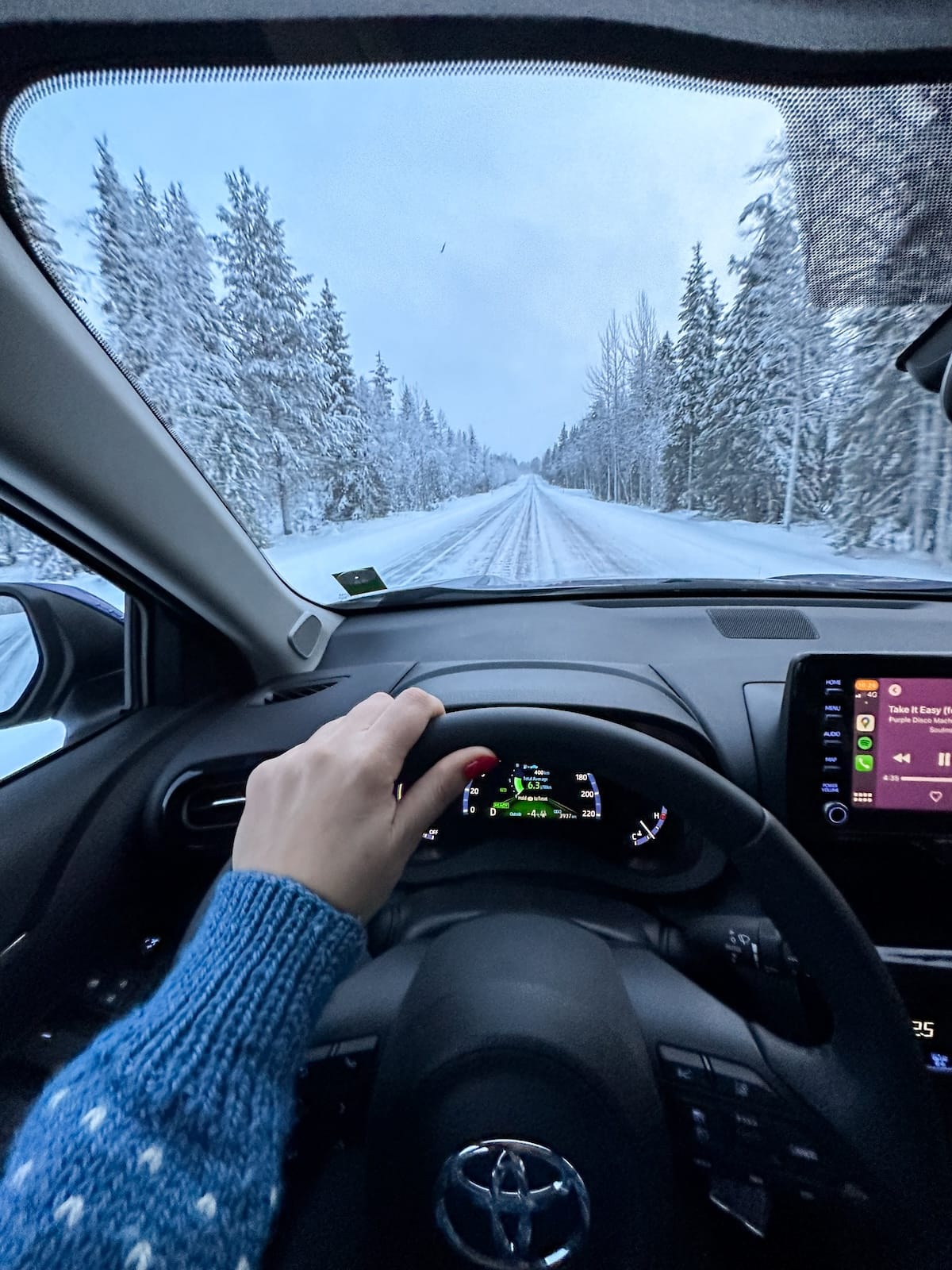 a woman driving a rental car in lapland