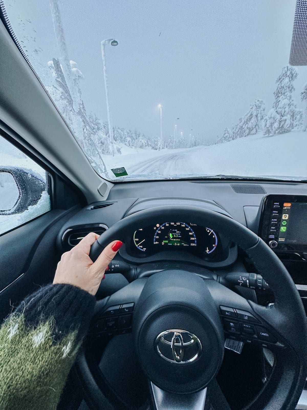 a woman driving a rental car in lapland