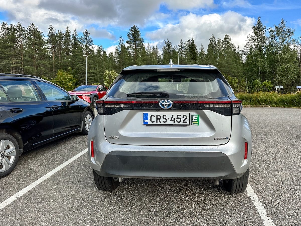 a silver rental car in the summer in lapland in a parking lot
