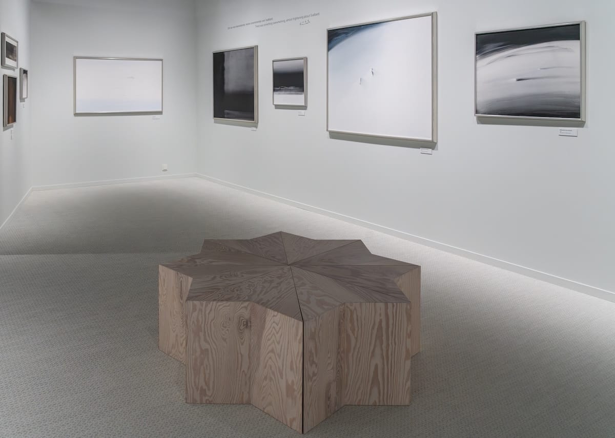 a collection of paintings in a minimalistic museum in svalbard