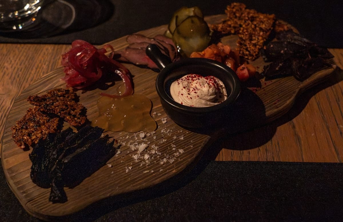 a dark restaurant with a plate of tasters from svalbard