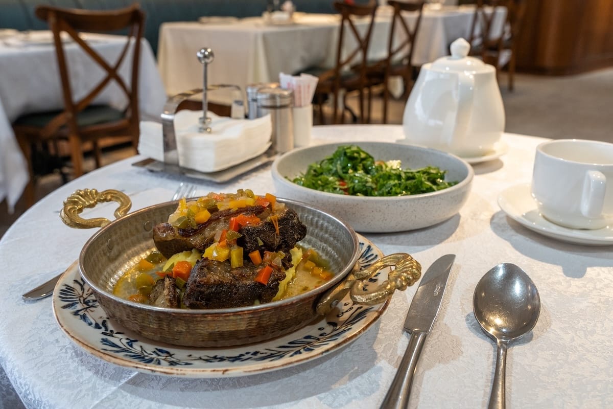 A local lamb dish at Ayvan
a dish of lamb with a side salad at a restaurant in uzbekistan