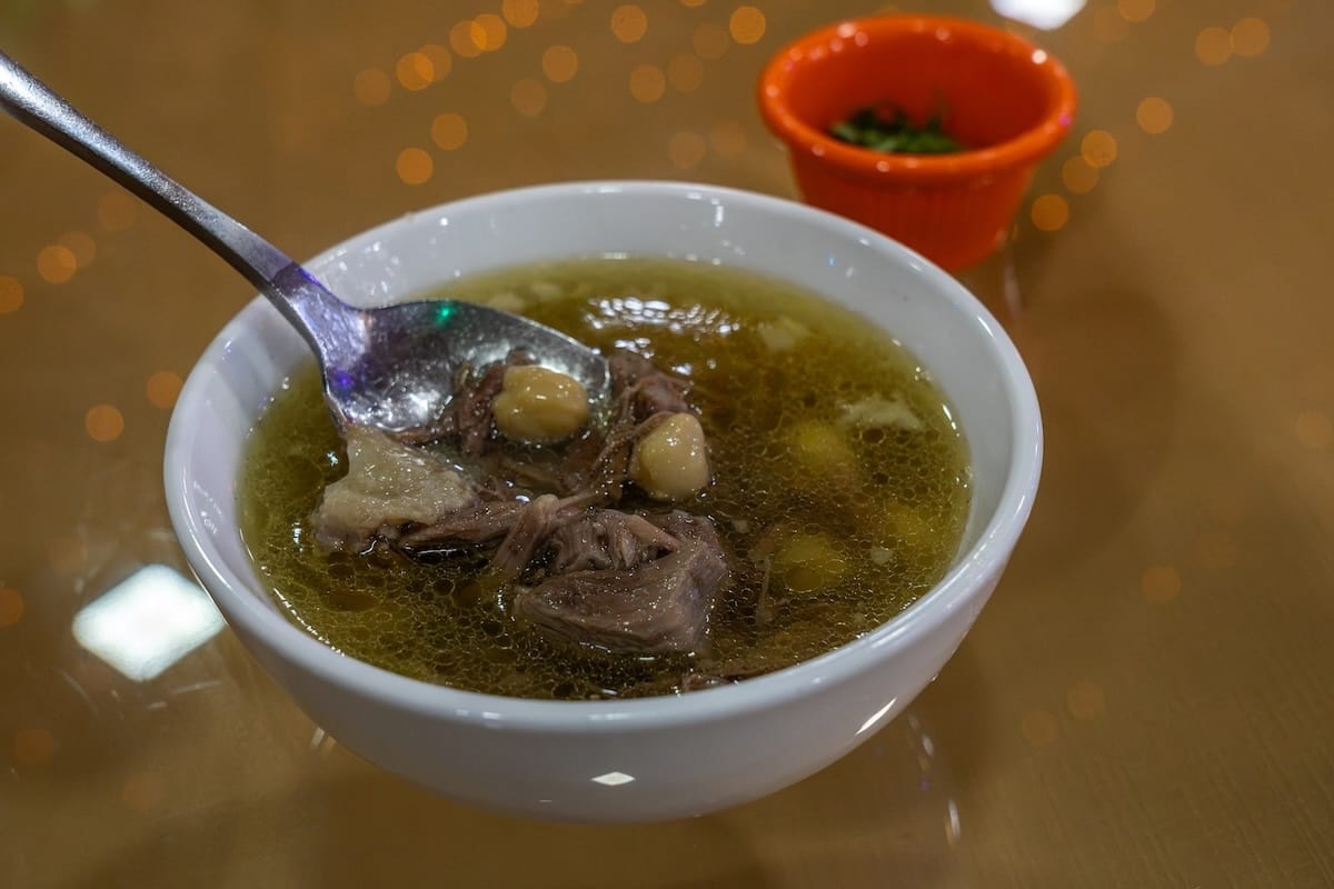 Bowl of balaza soup with tender meat and chickpeas at Chinor restaurant in Bukhara, Uzbekistan