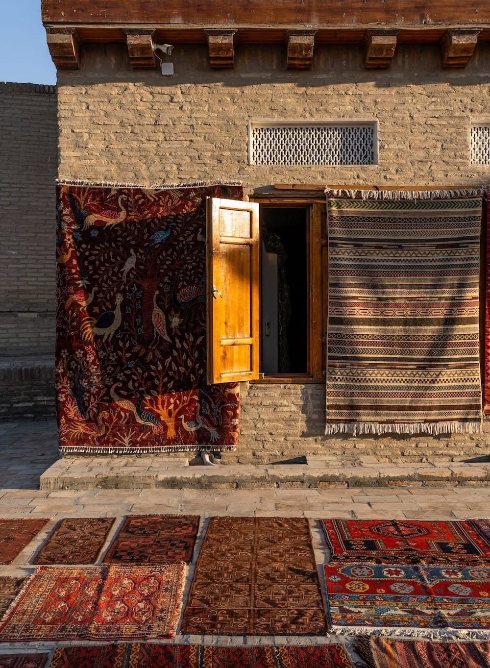 carpets hanging on a buildings facade in uzbekistan