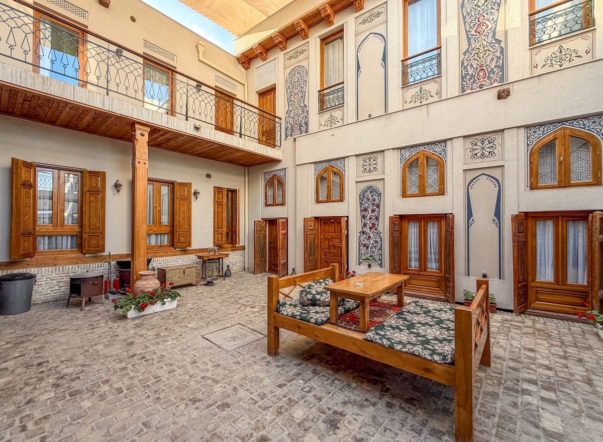 Duston Boutique Hotel in Bukhara
a courtyard of a boutique hotel in uzbekistan with a tapchan and rooms