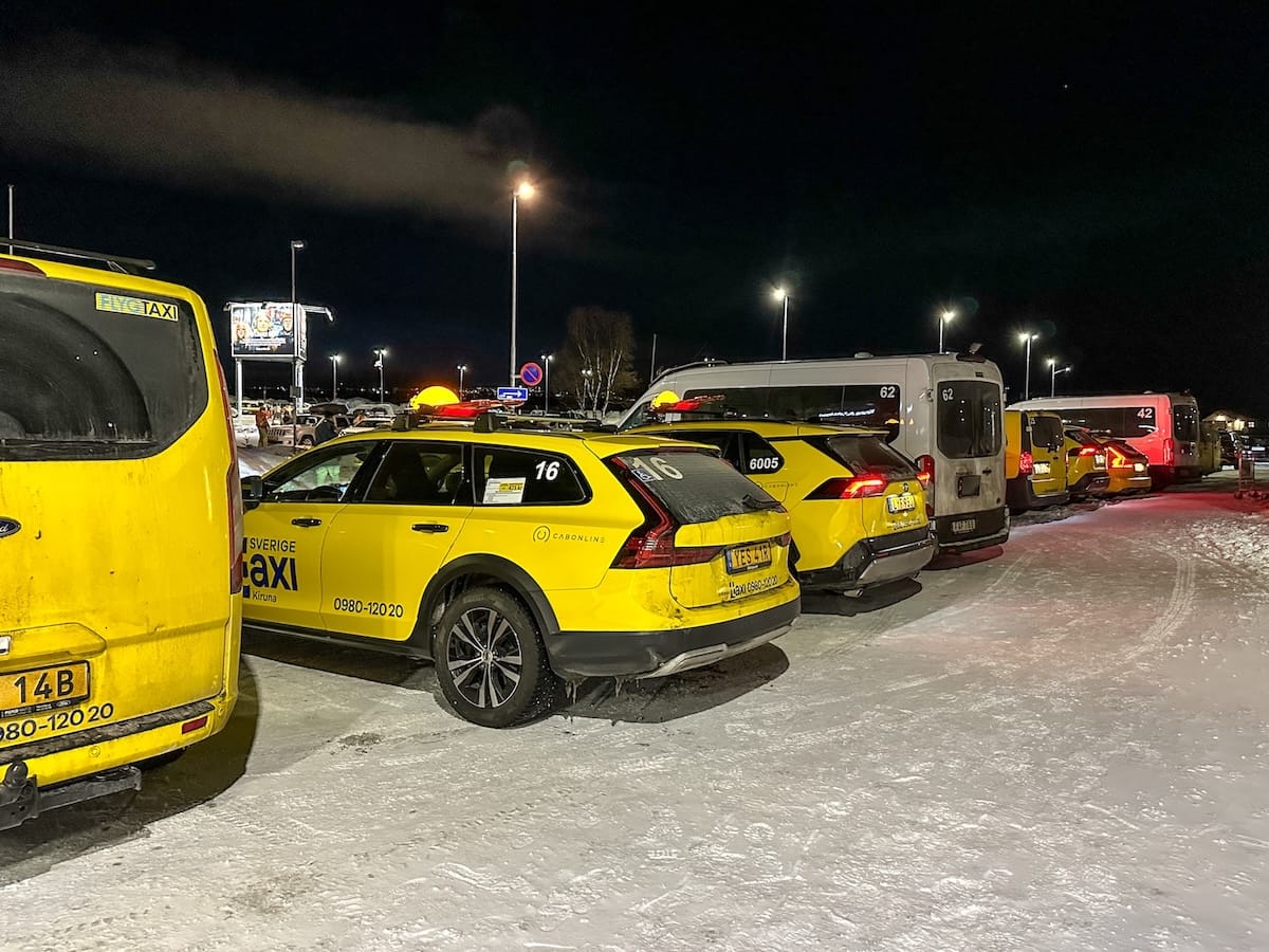 a bunch of yellow taxis in snow at Kiruna Airport