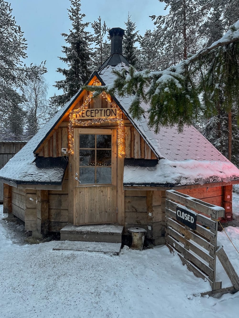 a small wooden hut with pine trees around it in finland