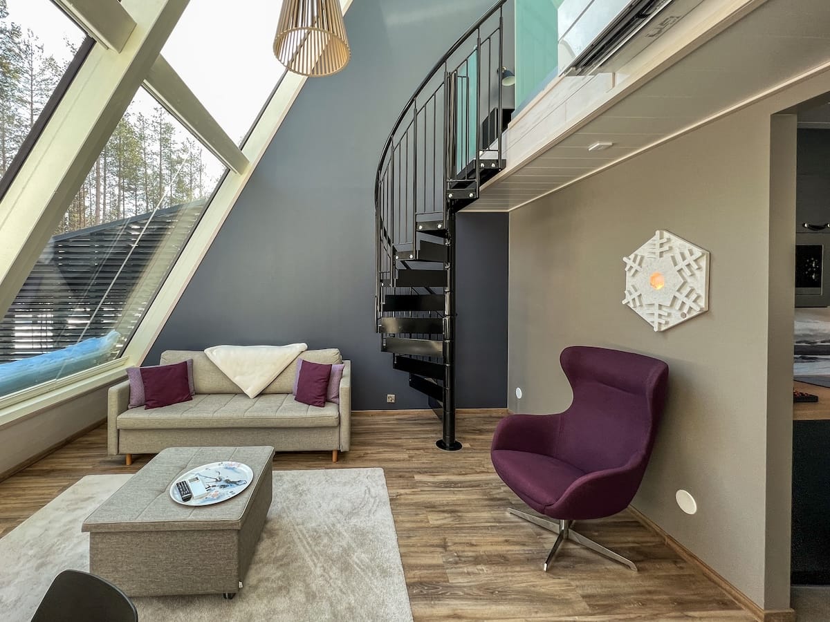Glass Resort
the inside of an apartment hotel at santa claus village with a staircase and glass roof