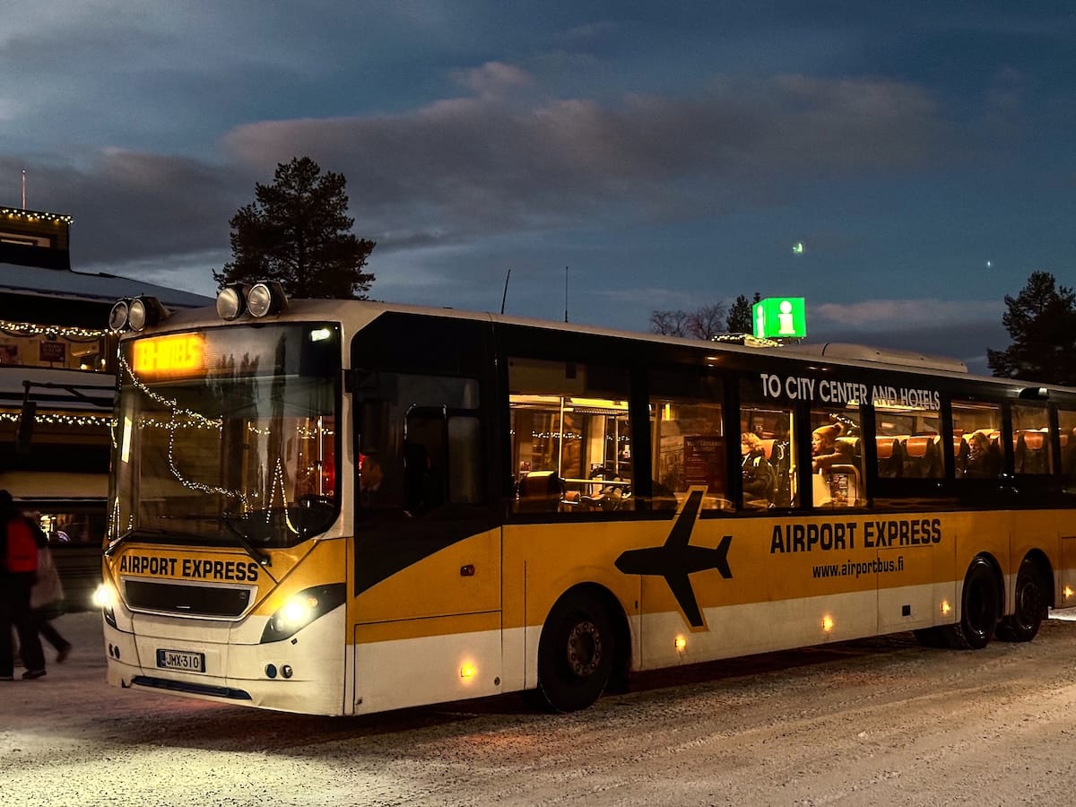 The Airport Express bus in Rovaniemi
a yellow and black bus picking people up in rovaniemi
