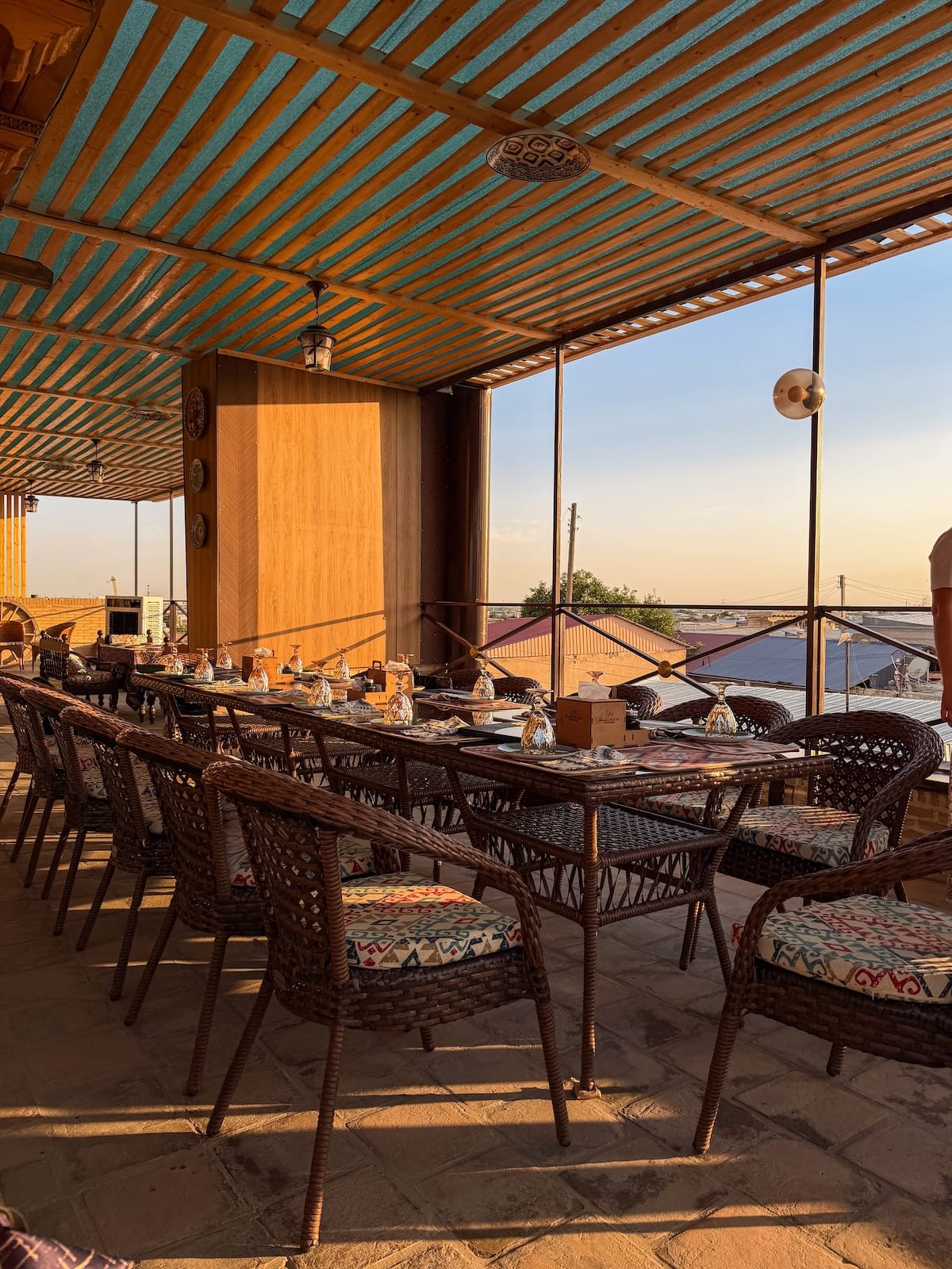 Rooftop terrace dining setup at sunset at Minorai Kalon Restaurant and Terrace in Bukhara, Uzbekistan