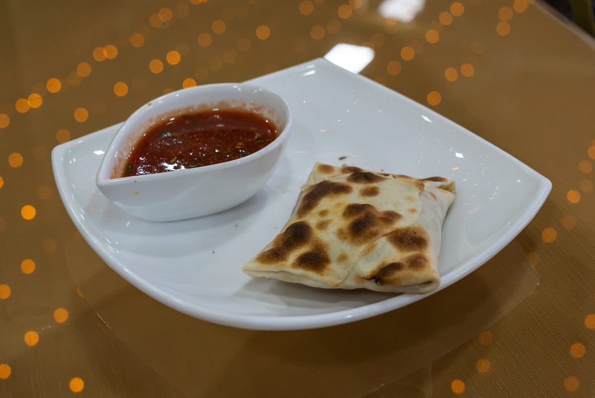 Freshly baked samsa served with tomato sauce at Olot restaurant in Bukhara, Uzbekistan