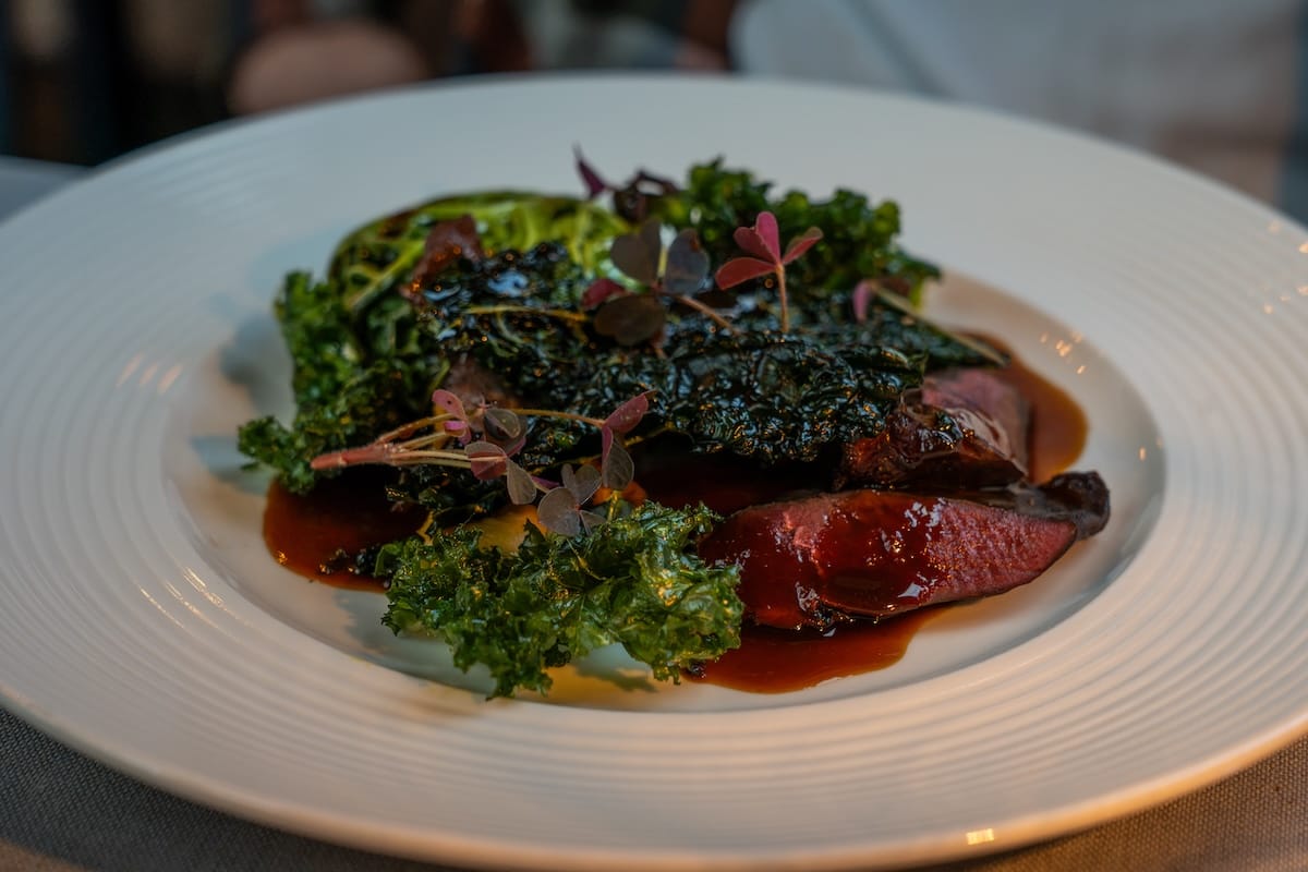 a plate of colorful kale and ptarmigan