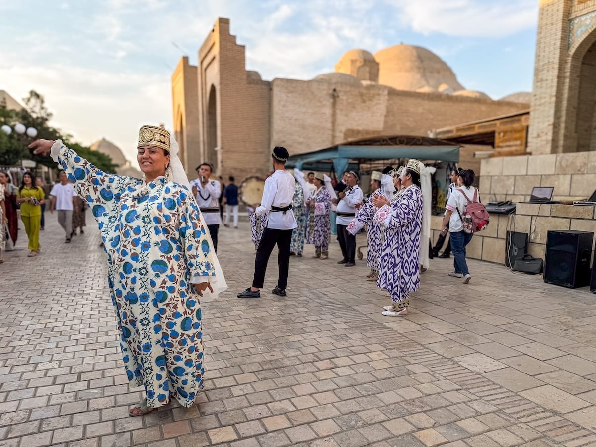 a woman dancing in bukhara's historic center