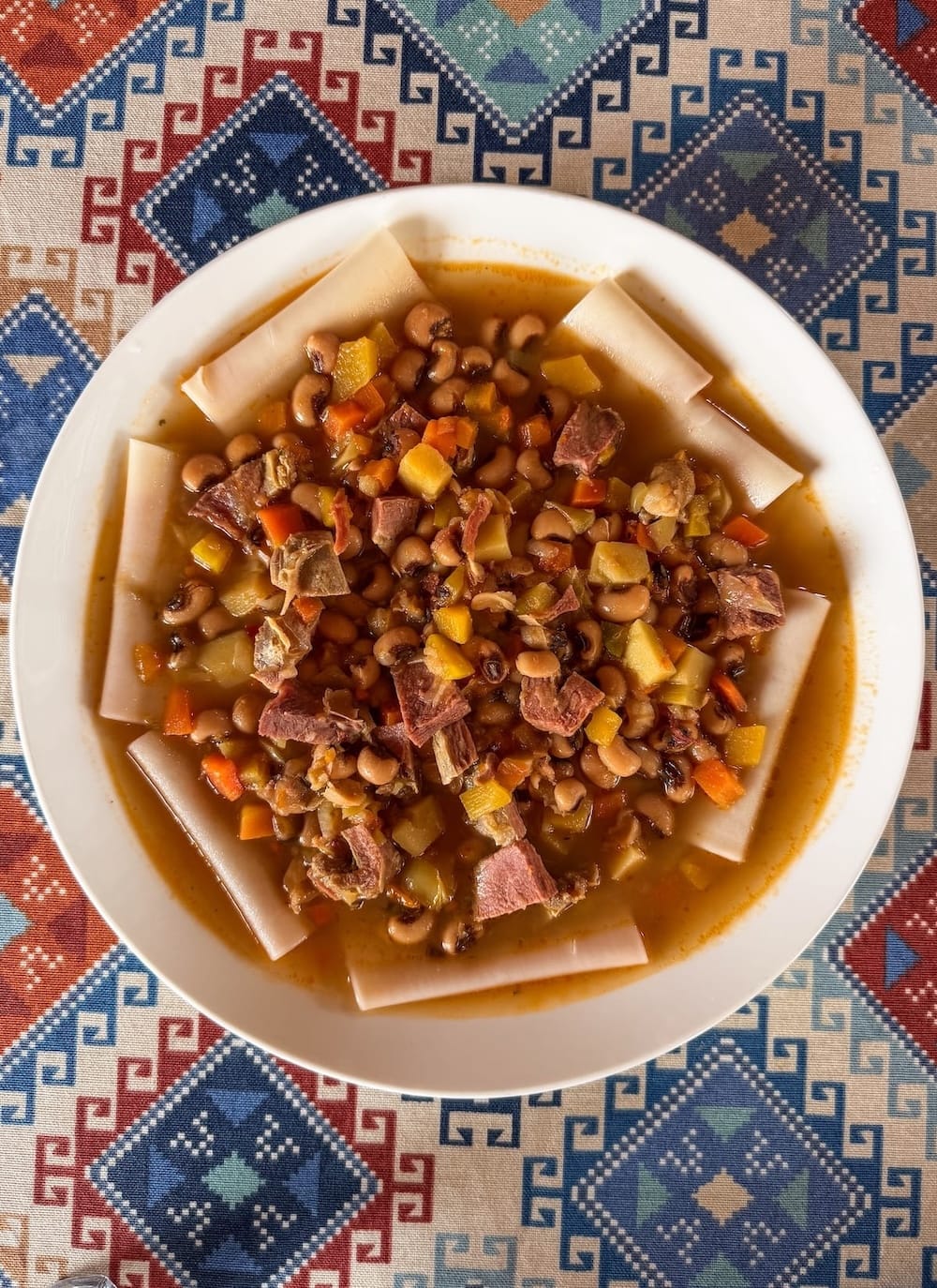 Bowl of kayish shilpildok stew with black-eyed peas, beef, and noodles at Xon Atlas restaurant in Bukhara, Uzbekistan