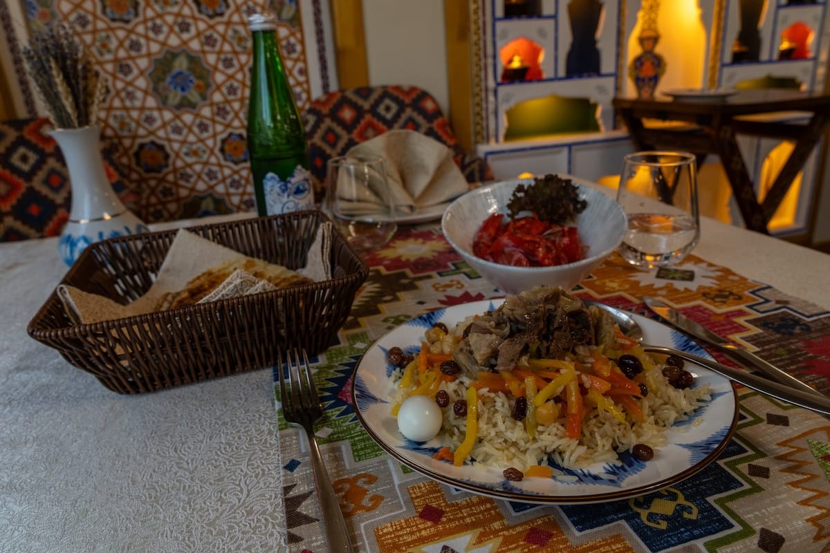 Plate of plov with egg, raisins, and vegetables at Zolotaya Buhara restaurant in Bukhara, Uzbekistan