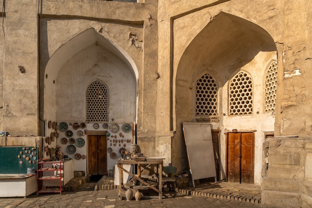 Ceramic shops inside the arched student cells of Abdulaziz Khan Madrasah in Bukhara, Uzbekistan