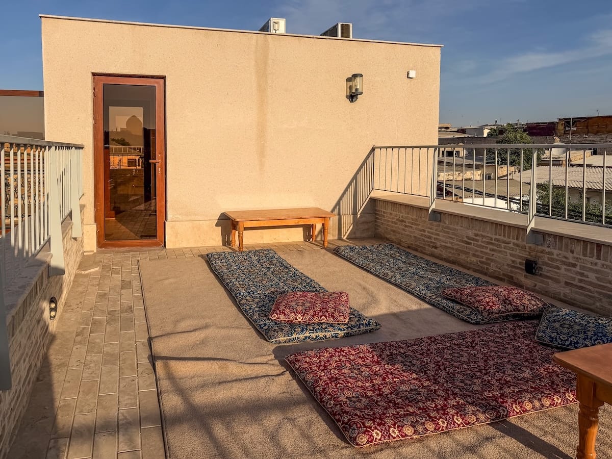 Rooftop terrace with floor cushions and mattresses at Duston Boutique Hotel in Bukhara, Uzbekistan