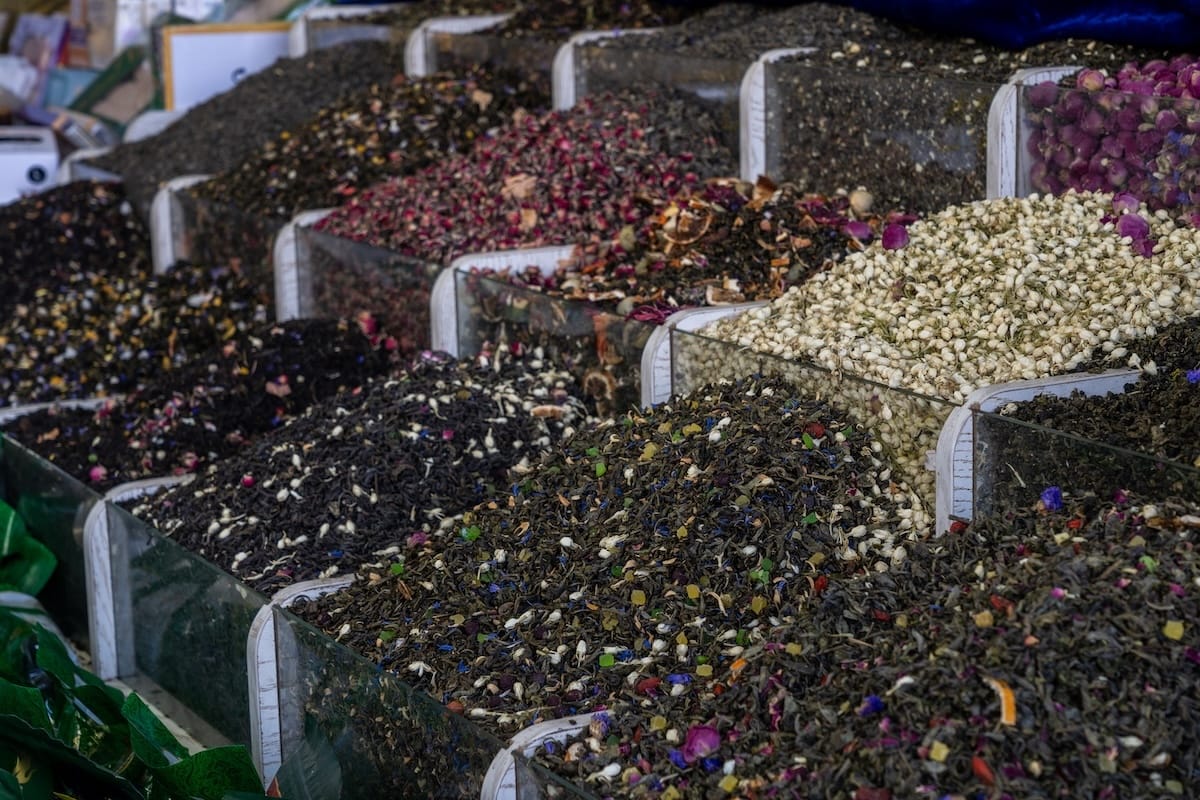 Bins of loose-leaf tea blends with dried rose and jasmine at Markaziy Bozor central market in Bukhara, Uzbekistan