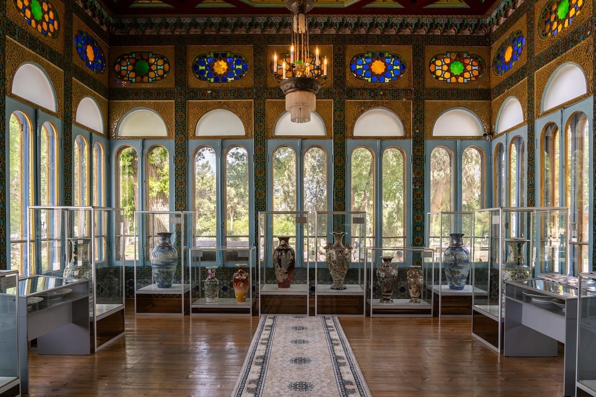 Stained glass windows and porcelain vase displays inside Sitorai Mokhi-Khosa Summer Palace in Bukhara, Uzbekistan